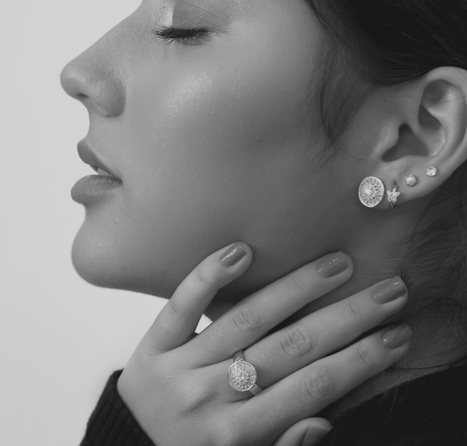 Woman wearing diamond earrings and ring